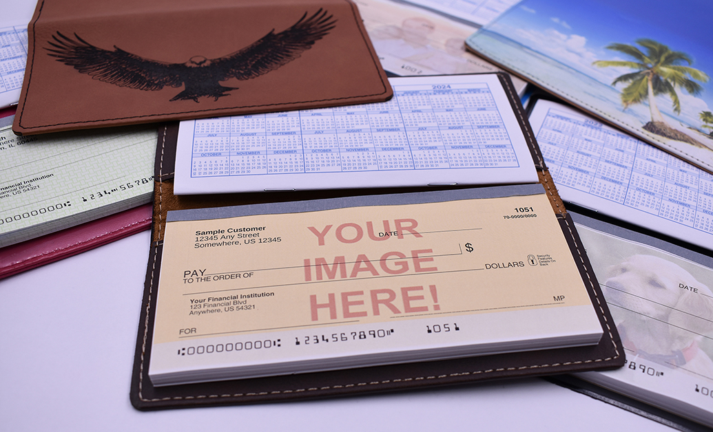 A collection of customized checkbook covers and sample checks featuring personalized engraving, tropical landscapes, and pet photography. The central checkbook highlights a "Your Image Here" placeholder, showcasing options for tailored financial stationery.